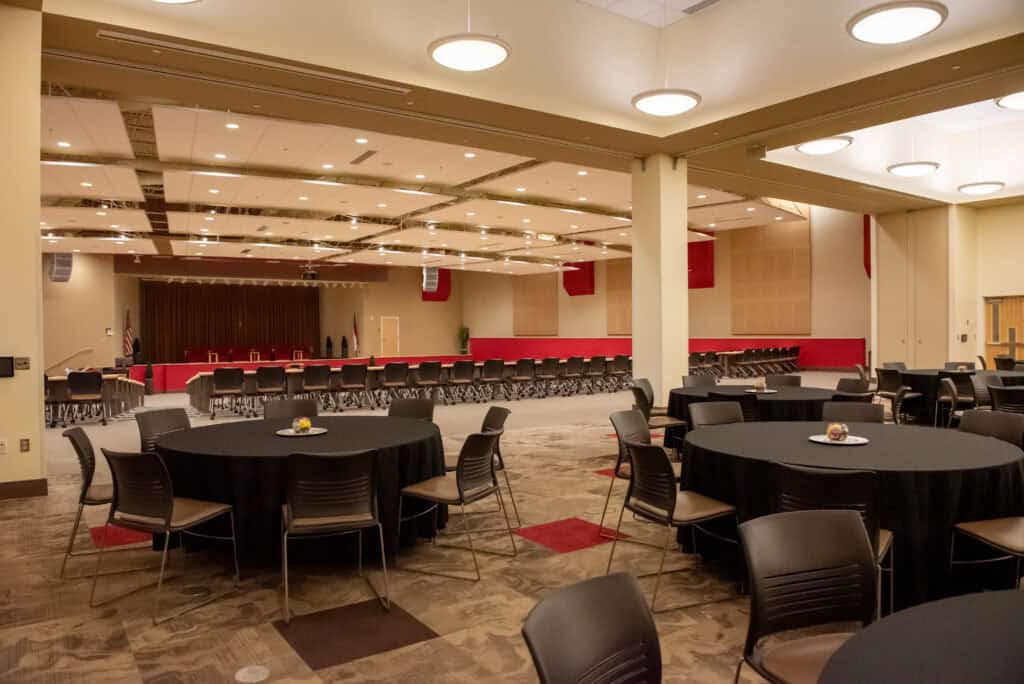 Grand Auditorium 5 Tables with black table cloths behind the seating in the GTCC Conference Center Grand Auditorium.